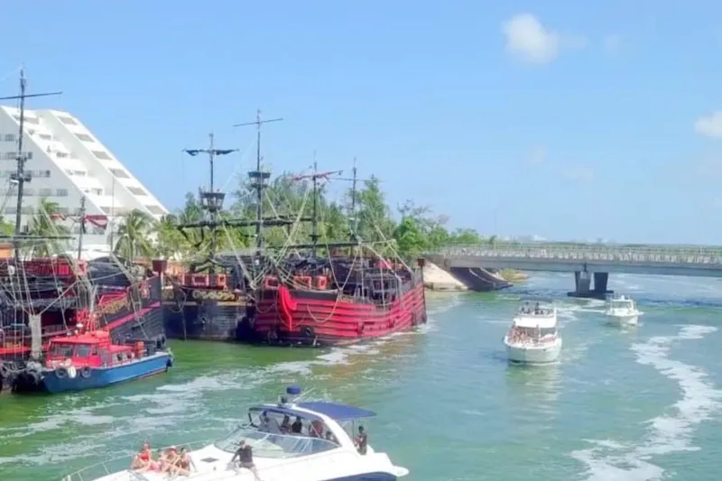 Sonata Yacht Photos Pics Boats and pirate ships on a sunny waterway near a bridge, featuring a 1999 Sea Ray 460 Express Cruiser.