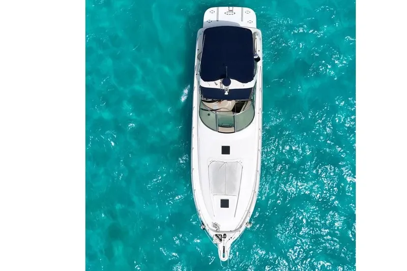 Sonata Yacht Photos Pics 1999 Sea Ray 460 Express Cruiser on clear turquoise water, aerial view.