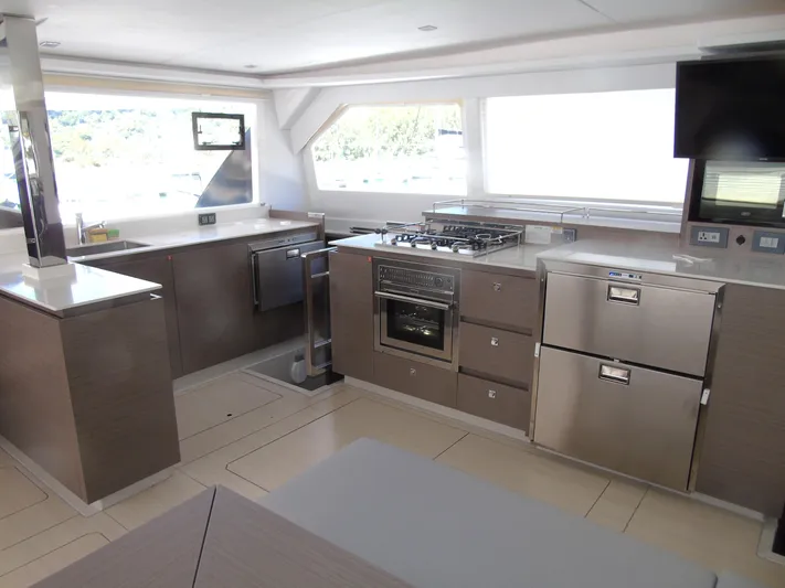  Yacht Photos Pics Modern kitchen interior on 2024 Leopard 50 yacht, featuring stainless steel appliances and sleek design.