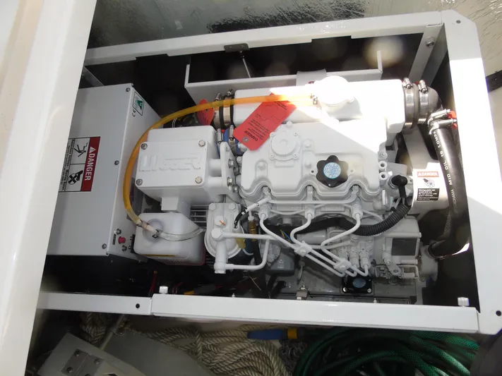 Tafika Yacht Photos Pics Engine compartment of a 2024 Leopard 50 yacht, showcasing mechanical components and warning labels.