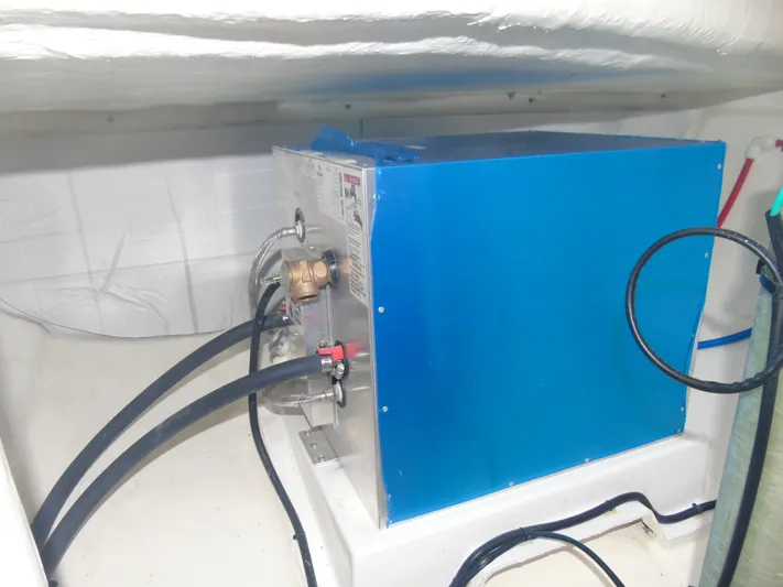 Tafika Yacht Photos Pics 2024 Leopard 50 yacht engine compartment with blue machinery and hoses.