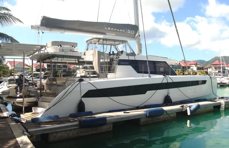  Yacht Photos Pics 2024 Leopard 50 catamaran docked at marina, featuring sleek design and modern amenities.