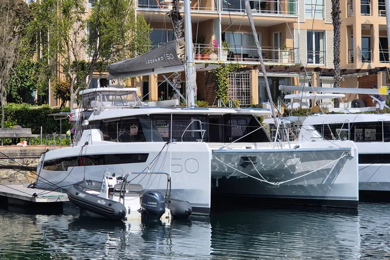 Tafika Yacht Photos Pics 2024 Leopard 50 catamaran docked at marina, modern design, luxury yacht.