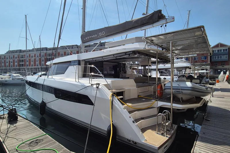 Tafika Yacht Photos Pics 2024 Leopard 50 yacht docked at marina, showcasing sleek design and modern features.