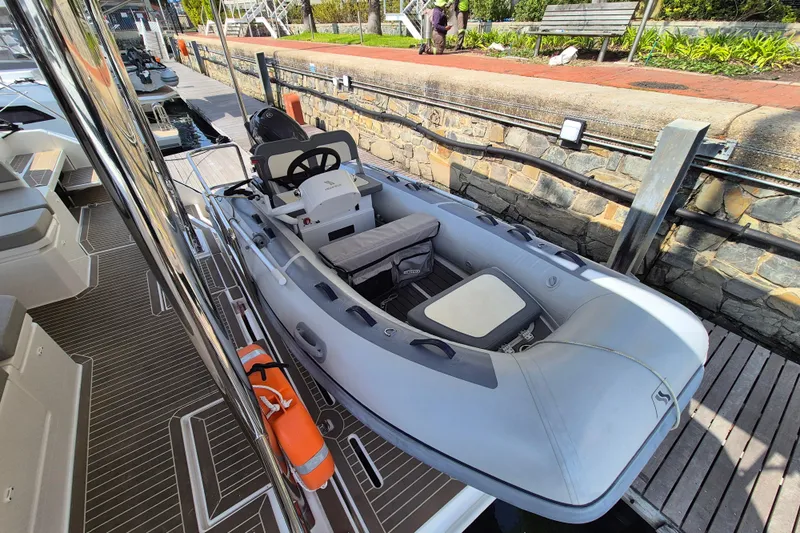 Tafika Yacht Photos Pics 2024 Leopard 50 inflatable boat docked, featuring a sleek design and modern seating.