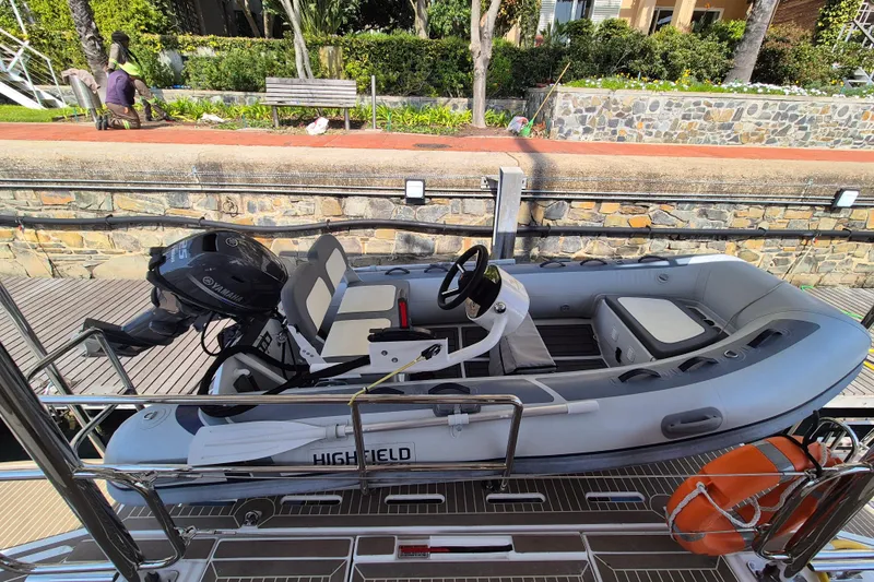 Tafika Yacht Photos Pics Inflatable boat with Yamaha motor docked near stone wall, 2024 Leopard 50 model.