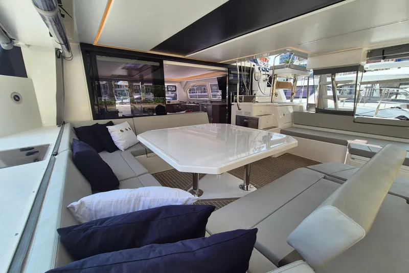 Tafika Yacht Photos Pics Luxurious interior of 2024 Leopard 50 yacht with modern seating and dining area.