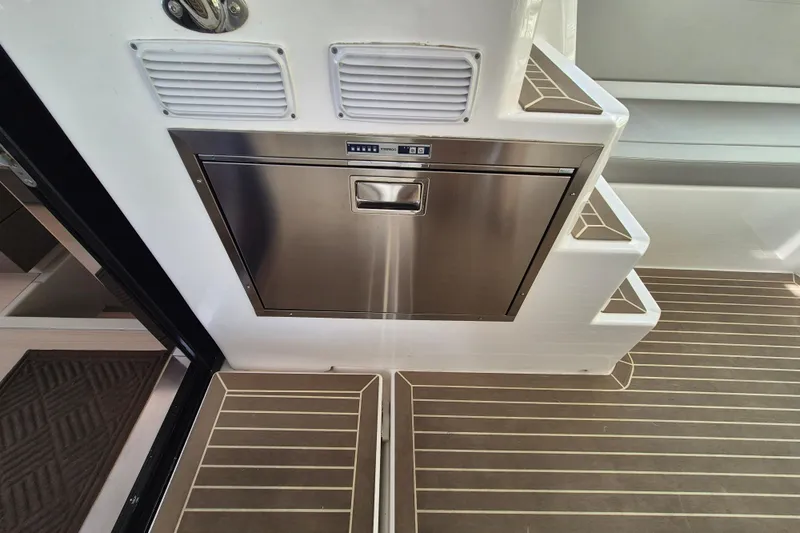 Tafika Yacht Photos Pics Stainless steel drawer on 2024 Leopard 50 yacht with wooden flooring and steps.