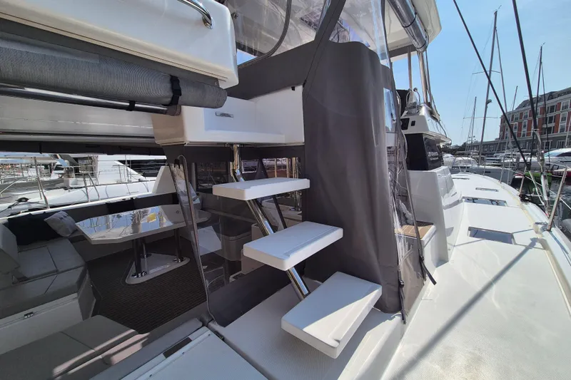 Tafika Yacht Photos Pics 2024 Leopard 50 yacht with modern interior and exterior design, docked at a marina.