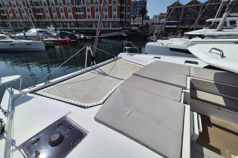 Tafika Yacht Photos Pics 2024 Leopard 50 catamaran docked in marina, featuring spacious deck and netting.