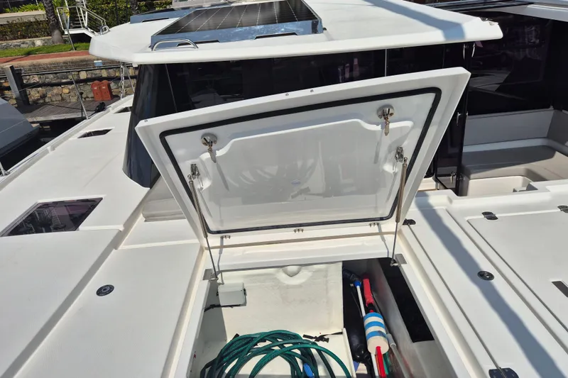 Tafika Yacht Photos Pics 2024 Leopard 50 yacht deck with open storage compartment and solar panels.