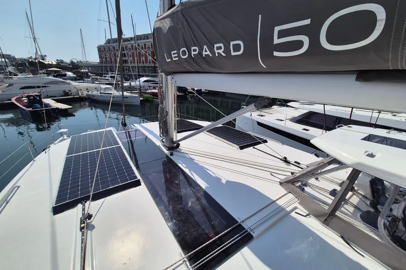 Tafika Yacht Photos Pics 2024 Leopard 50 catamaran with solar panels docked at a marina.