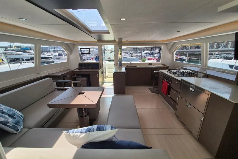 Tafika Yacht Photos Pics Luxurious interior of 2024 Leopard 50 yacht with modern kitchen and seating area.