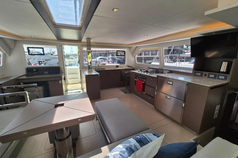 Tafika Yacht Photos Pics Luxurious interior of 2024 Leopard 50 yacht with modern kitchen and seating area.