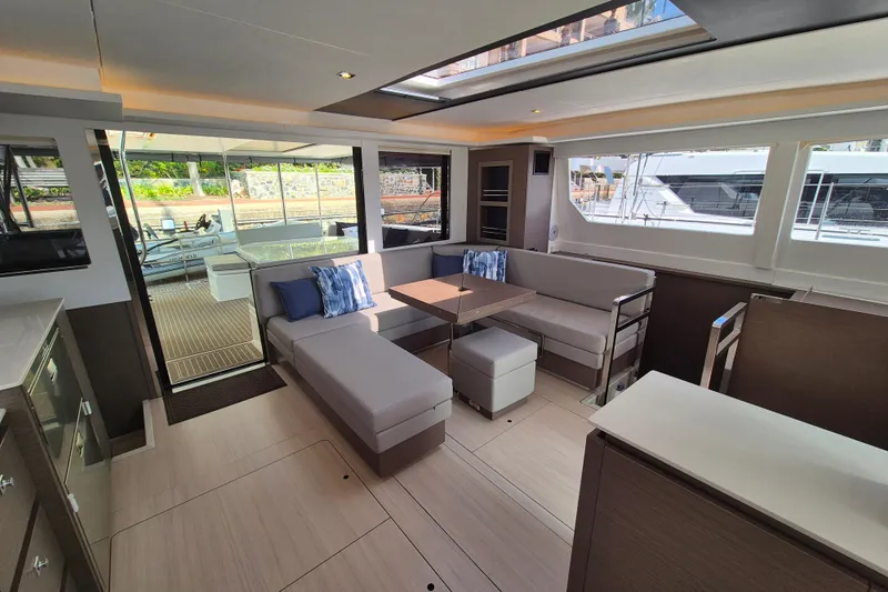 Tafika Yacht Photos Pics Luxurious interior of 2024 Leopard 50 yacht with modern seating and large windows.