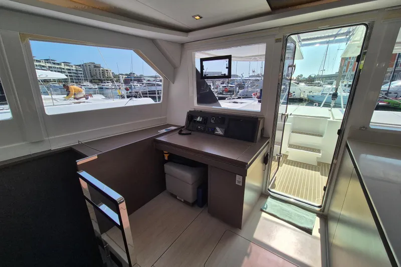Tafika Yacht Photos Pics Interior view of 2024 Leopard 50 yacht cockpit with marina in background.