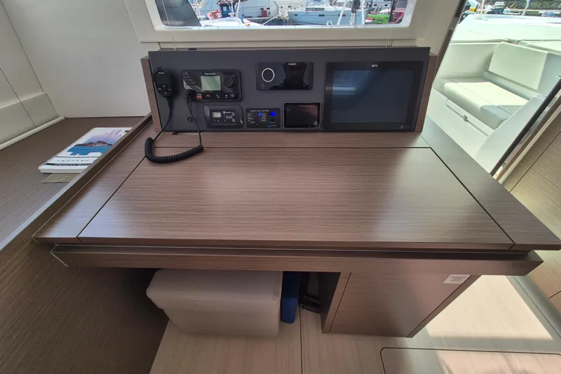 Tafika Yacht Photos Pics Navigation station in 2024 Leopard 50 yacht with control panel and seating.