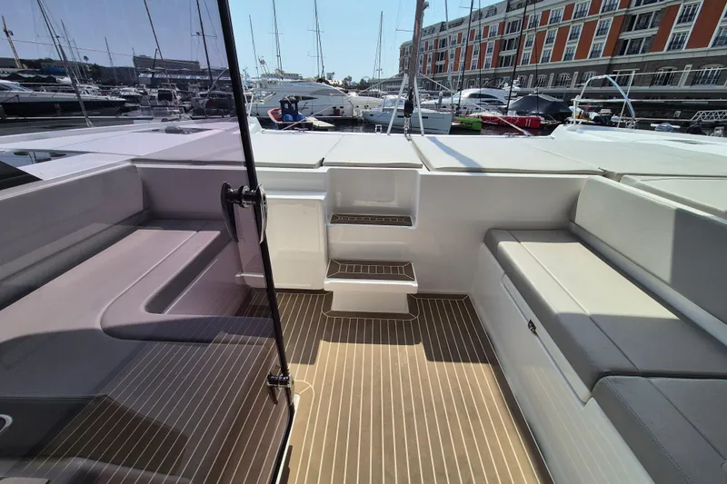Tafika Yacht Photos Pics 2024 Leopard 50 yacht deck with seating, steps, and marina view.