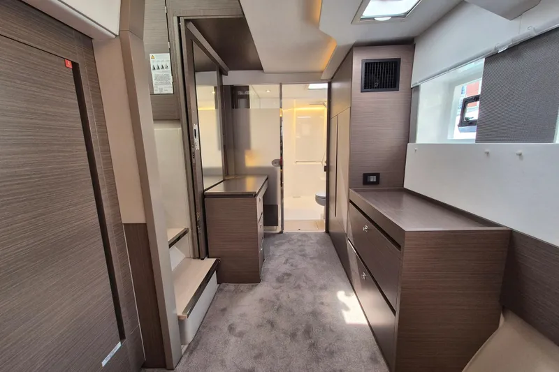 Tafika Yacht Photos Pics Luxurious interior of 2024 Leopard 50 yacht with modern wood finishes and ample storage.