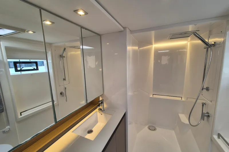 Tafika Yacht Photos Pics Modern bathroom in 2024 Leopard 50 yacht with sleek shower and mirrored cabinets.