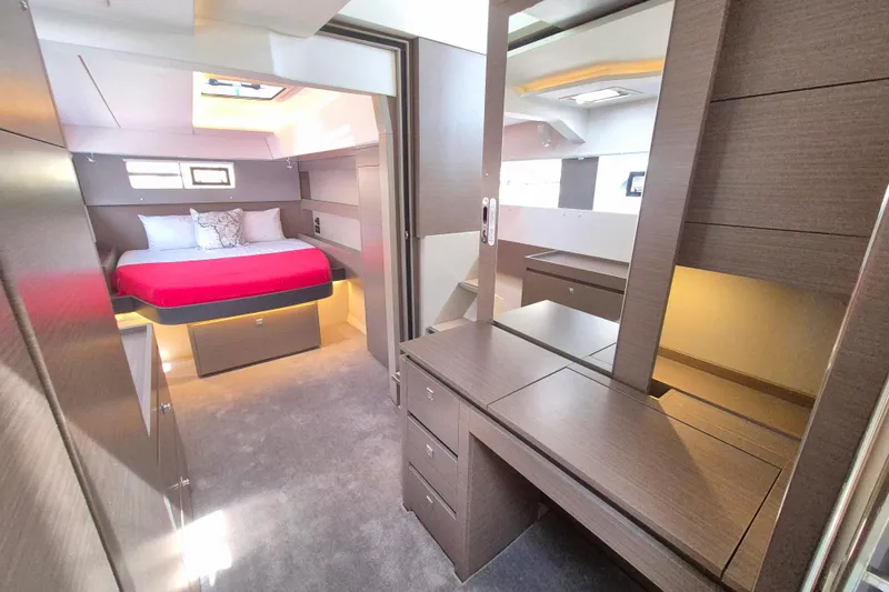 Tafika Yacht Photos Pics Luxurious 2024 Leopard 50 yacht interior with modern bedroom and vanity area.