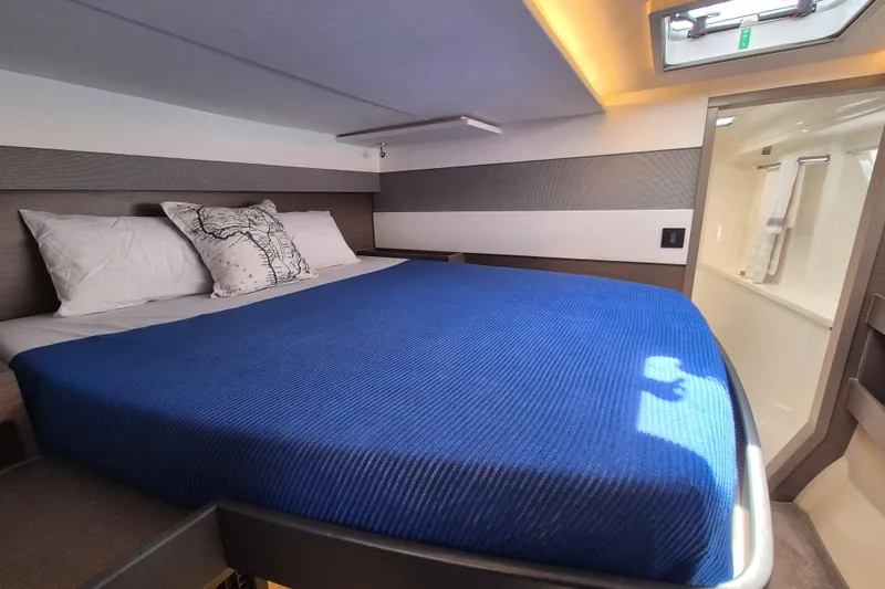 Tafika Yacht Photos Pics Luxurious cabin interior of 2024 Leopard 50 yacht with blue bedding and modern design.