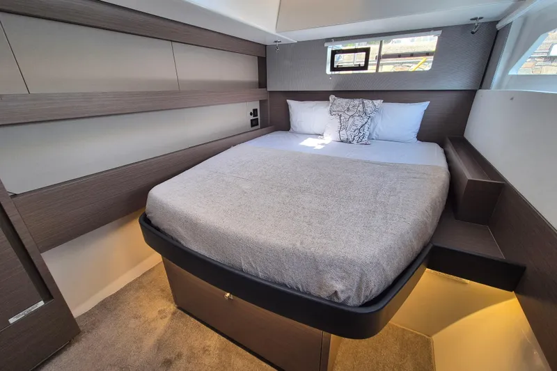 Tafika Yacht Photos Pics Luxurious bedroom interior of 2024 Leopard 50 yacht with modern design and cozy bedding.