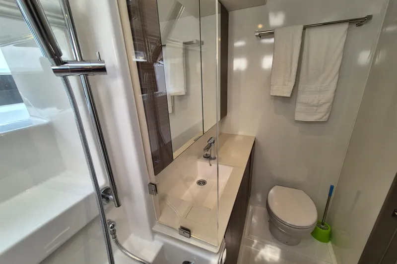 Tafika Yacht Photos Pics Modern bathroom in 2024 Leopard 50 yacht with shower, sink, and toilet.