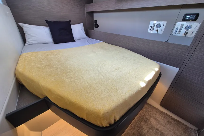 Tafika Yacht Photos Pics Cozy cabin bed in 2024 Leopard 50 yacht with modern controls and soft lighting.
