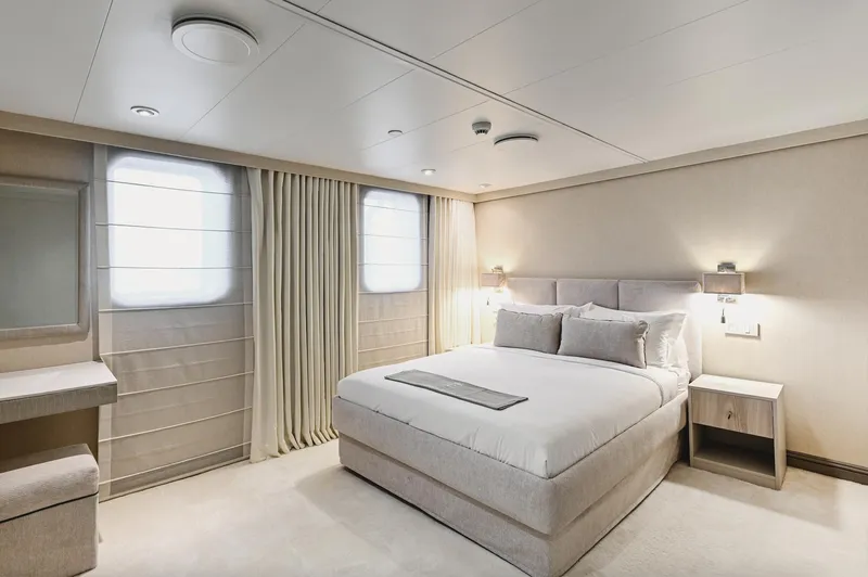 Chakra Yacht Photos Pics Luxurious bedroom interior on Devonport 86m yacht, featuring elegant decor and comfortable bedding.