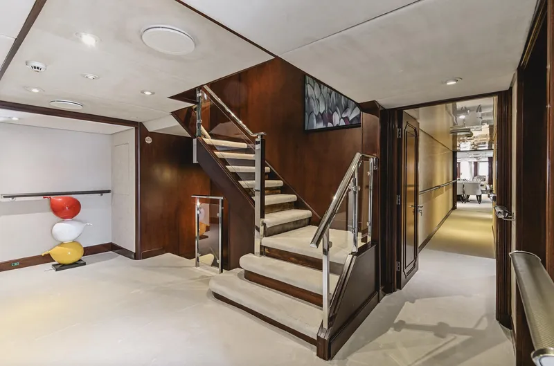 Chakra Yacht Photos Pics Luxurious interior of Devonport 86m yacht, featuring elegant staircase and modern decor, built in 1963.