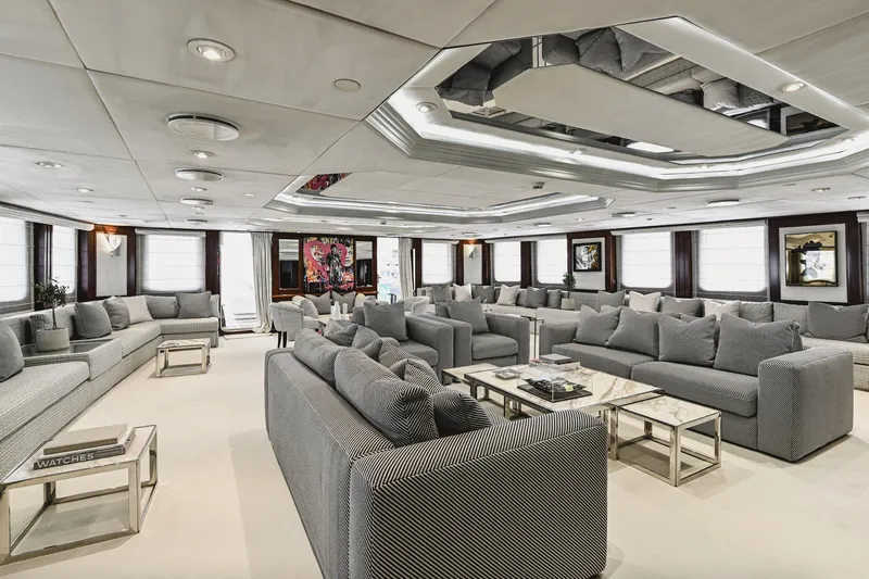 Chakra Yacht Photos Pics Luxurious yacht interior with modern gray sofas, elegant decor, and contemporary art. Devonport 86m, 1963.