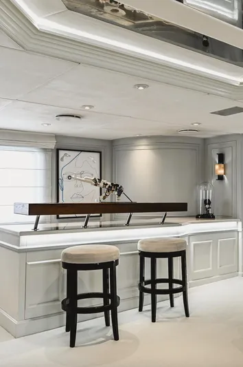 Chakra Yacht Photos Pics Luxurious yacht interior with modern bar, stools, and abstract artwork, Devonport 86m, 1963.