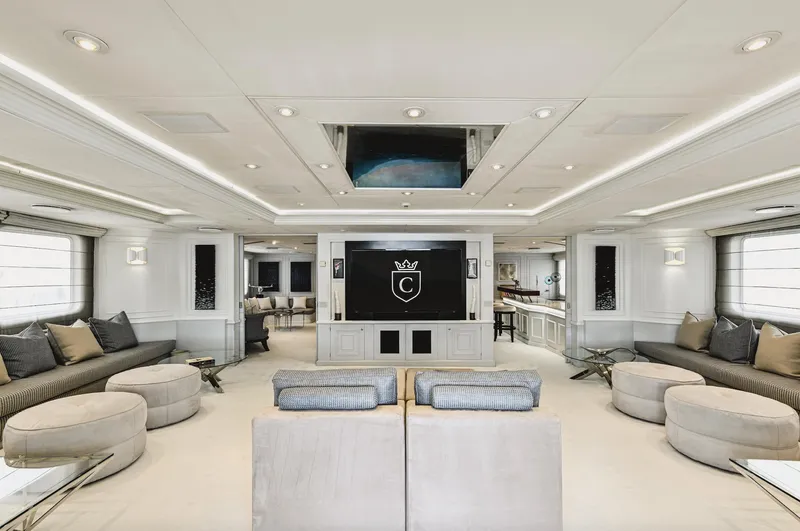 Chakra Yacht Photos Pics Luxurious yacht interior with modern decor, plush seating, and large TV, Devonport 86m, 1963 model.