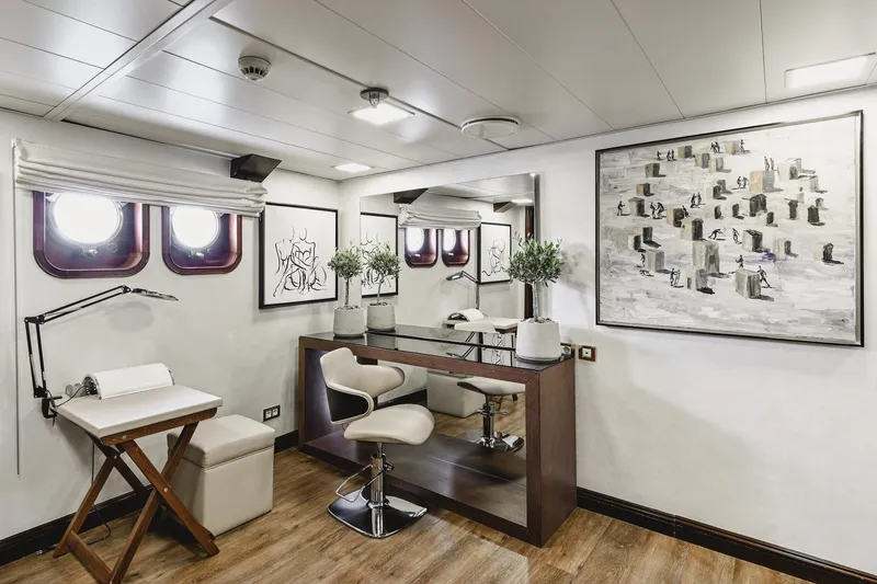 Chakra Yacht Photos Pics Luxurious yacht interior with modern decor, featuring art, portholes, and elegant furnishings. Devonport 86m, 1963.