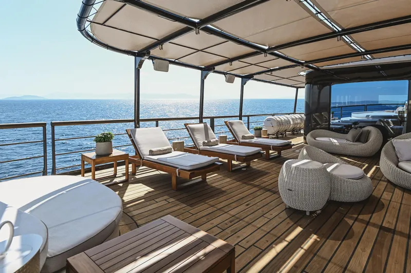 Chakra Yacht Photos Pics Luxurious yacht deck with sun loungers and ocean view, Devonport 86m, 1963 model.