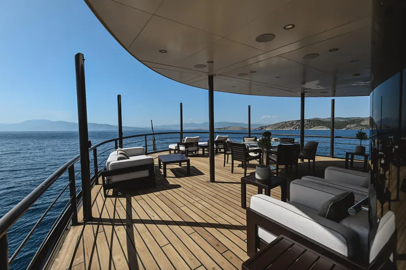 Chakra Yacht Photos Pics Luxurious yacht deck with seating, ocean view, and clear blue sky. Devonport 86m, 1963 model.