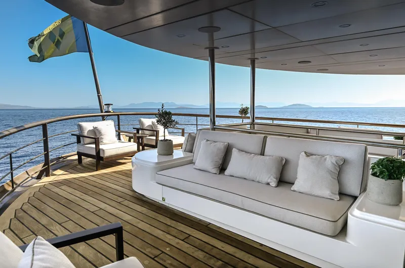 Chakra Yacht Photos Pics Luxurious yacht deck with comfortable seating, ocean view, and elegant decor. Devonport 86m, 1963.