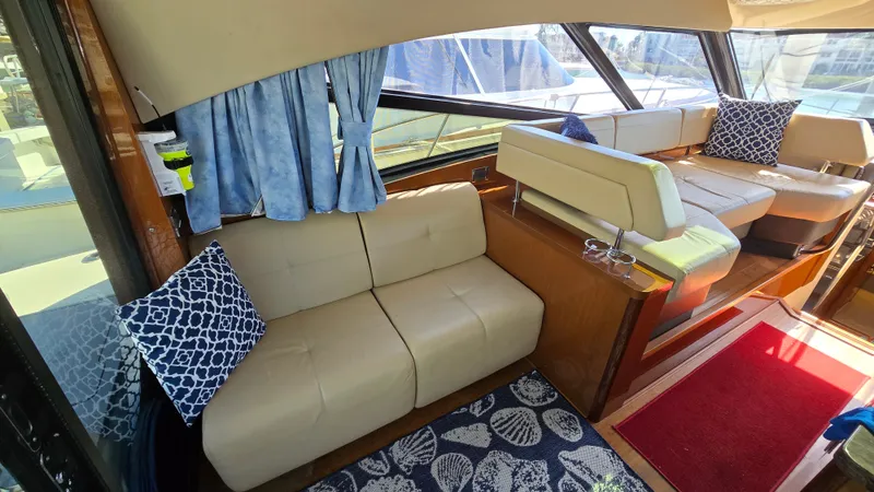  Yacht Photos Pics Interior of 2015 Sea Ray 470 Sundancer with beige sofas and blue cushions.
