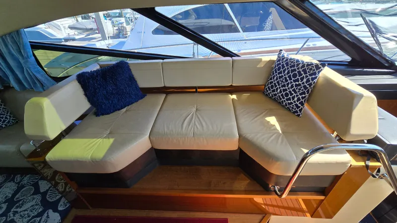  Yacht Photos Pics Interior of 2015 Sea Ray 470 Sundancer with beige sofa and blue cushions.