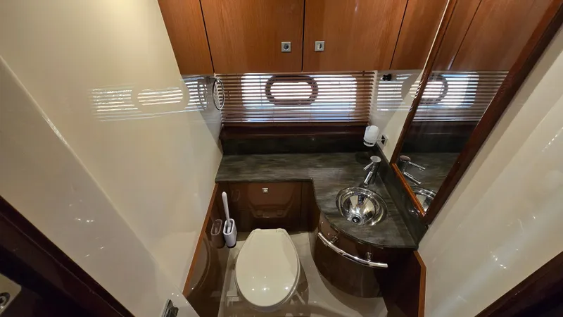  Yacht Photos Pics Luxurious bathroom of 2015 Sea Ray 470 Sundancer with wood paneling.