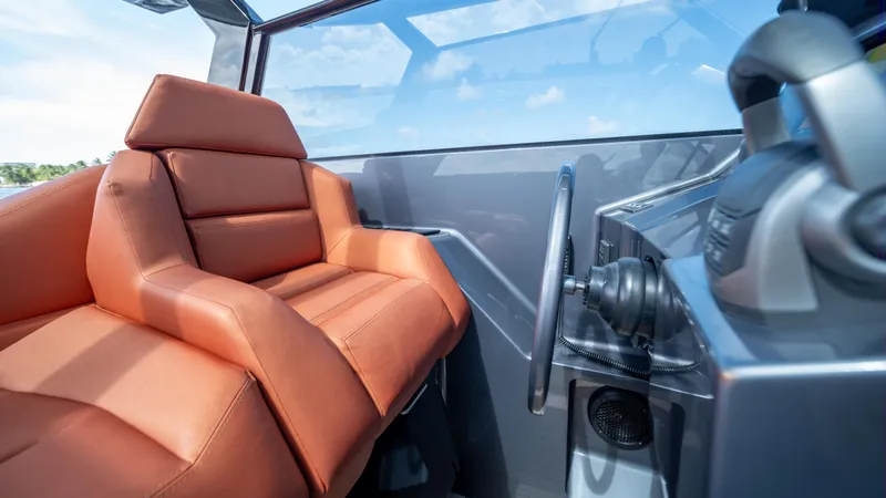 Pharmasea Yacht Photos Pics 2022 Vanquish Yachts VQ45 interior with luxurious leather seating and modern steering console.