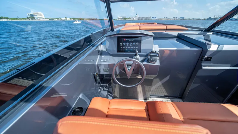 Pharmasea Yacht Photos Pics Interior view of 2022 Vanquish Yachts VQ45, featuring modern dashboard and leather seating.