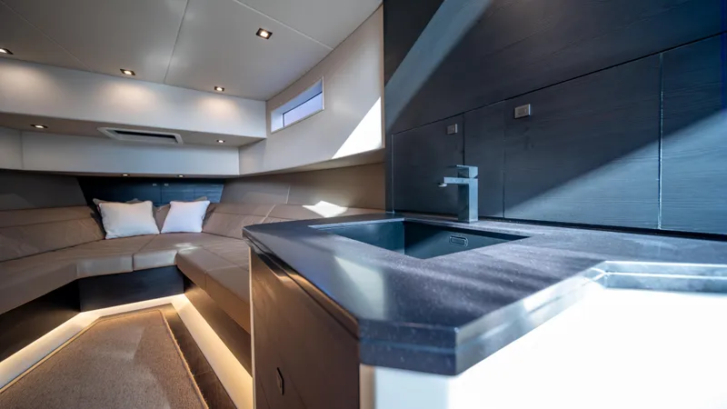 Pharmasea Yacht Photos Pics Luxurious interior of 2022 Vanquish Yachts VQ45 with modern kitchen and seating area.