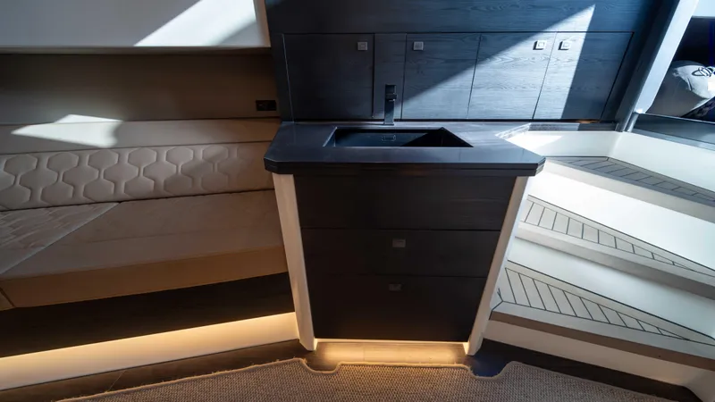 Pharmasea Yacht Photos Pics Interior of 2022 Vanquish Yachts VQ45, featuring modern cabinetry and sleek design elements.