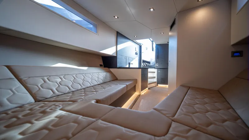 Pharmasea Yacht Photos Pics Luxurious interior of 2022 Vanquish Yachts VQ45 with modern seating and ambient lighting.