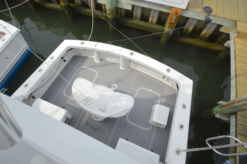 Fish Repellent Yacht Photos Pics 1998 Post 42 Convertible boat docked, featuring spacious deck and covered equipment.