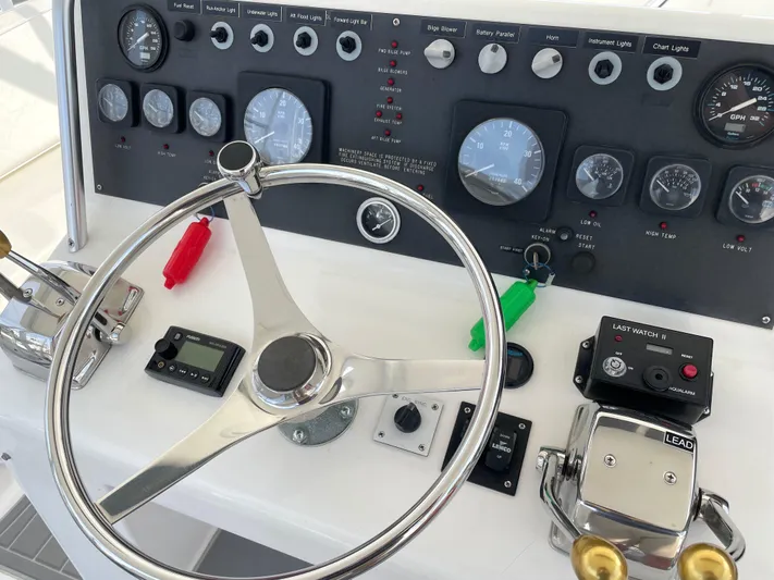 Fish Repellent Yacht Photos Pics Control panel of a 1998 Post 42 Convertible boat with steering wheel and gauges.