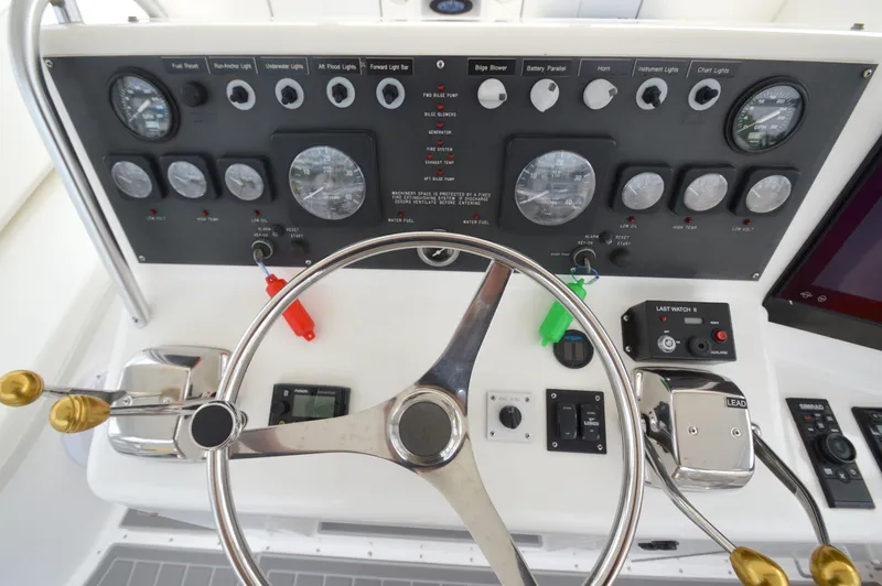 Fish Repellent Yacht Photos Pics Control panel of a 1998 Post 42 Convertible yacht with steering wheel and gauges.