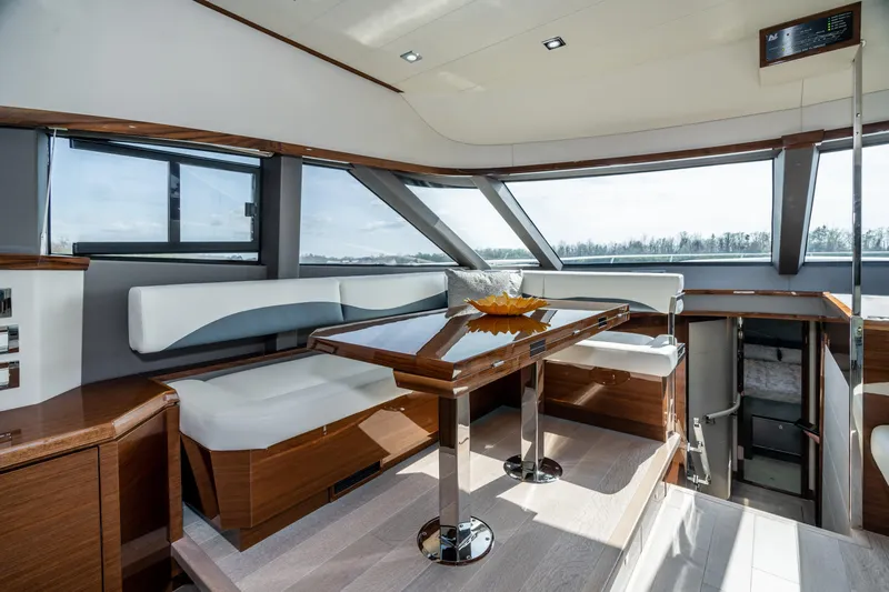  Yacht Photos Pics Luxurious interior of 2026 Neptunus 650F yacht with modern seating and panoramic windows.